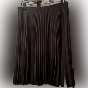 NWT, Pleated black skirt. This is a classic piece. Has slip attached
